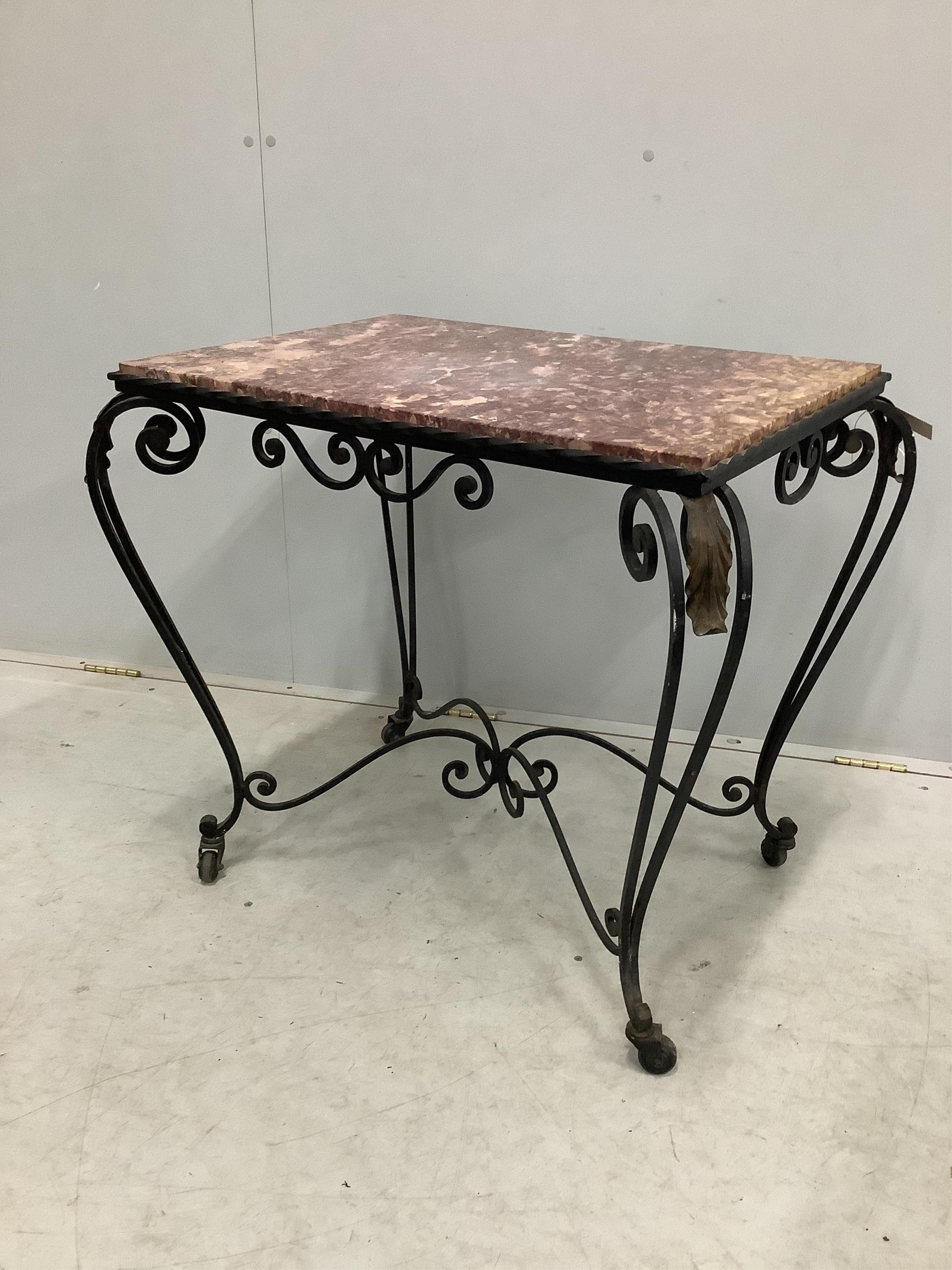 A rectangular wrought iron marble topped table, width 81cm, depth 58cm, height 68cm. Condition - fair